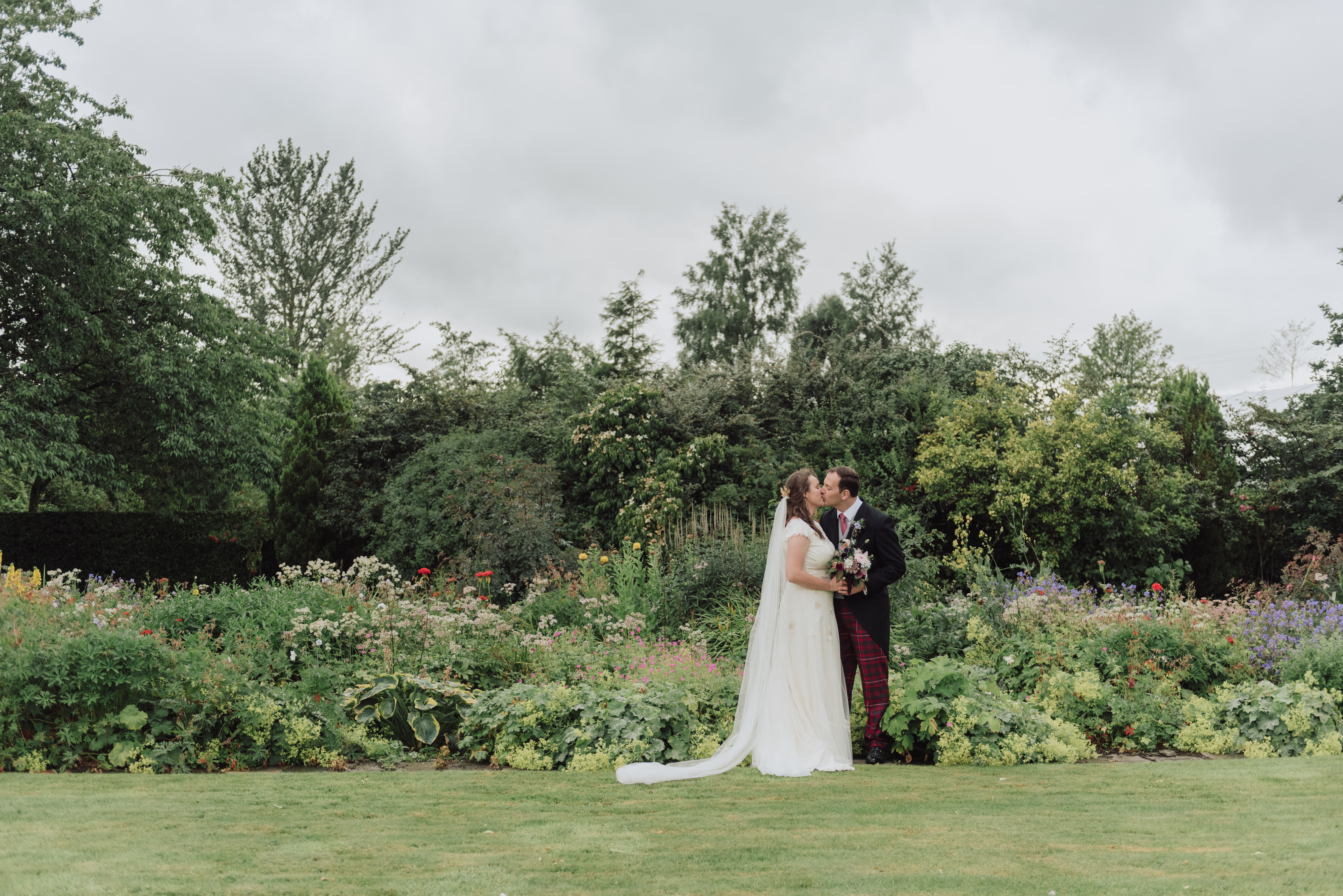 Flora and Macca share a kiss on their wedding day.